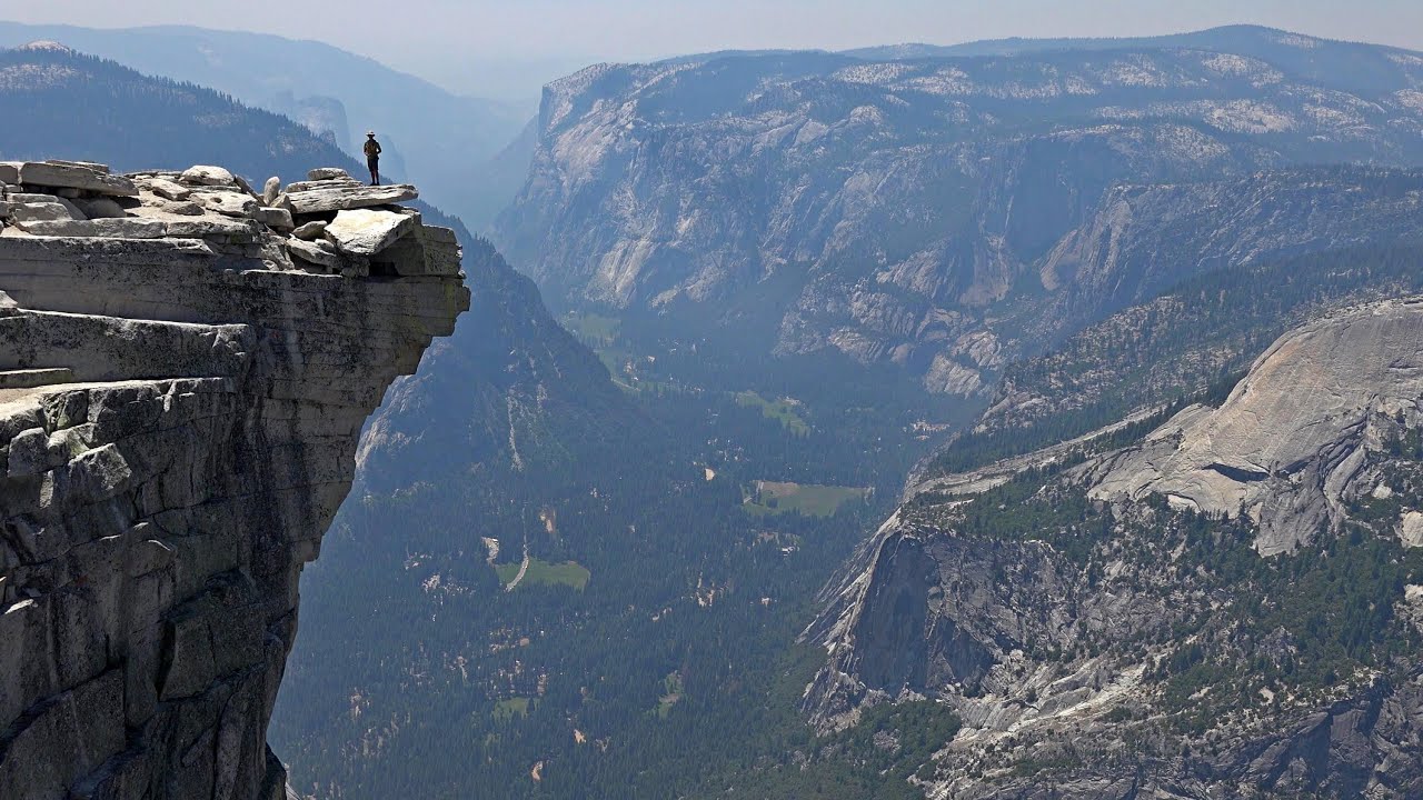 Man standing on sheer-edge of cliff